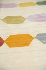 Hand woven Afghani Kilim showing abstract gold and grey pebble elements with abrashes.