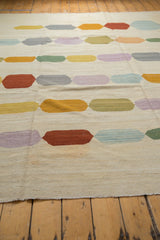 Afghani Kilim's secured side cord and abstract pebble shapes in pastel hues.