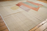 Hand woven texture of Afghani Kilim carpet's neutral ivory field and heavy abrashes.