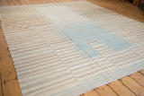 Afghani Kilim carpet showing staggered ivory, pale coffee, and blue serrated bands.
