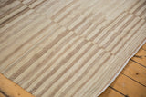 Handwoven Afghani Kilim rug with ivory and brown serrated banded texture and edge.