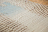 Afghani Kilim's hand-woven texture, serrated horizontal bands in ivory, coffee, and light blue.