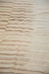 Afghani Kilim's horizontal striations and staggered weave in ivory and pale coffee.