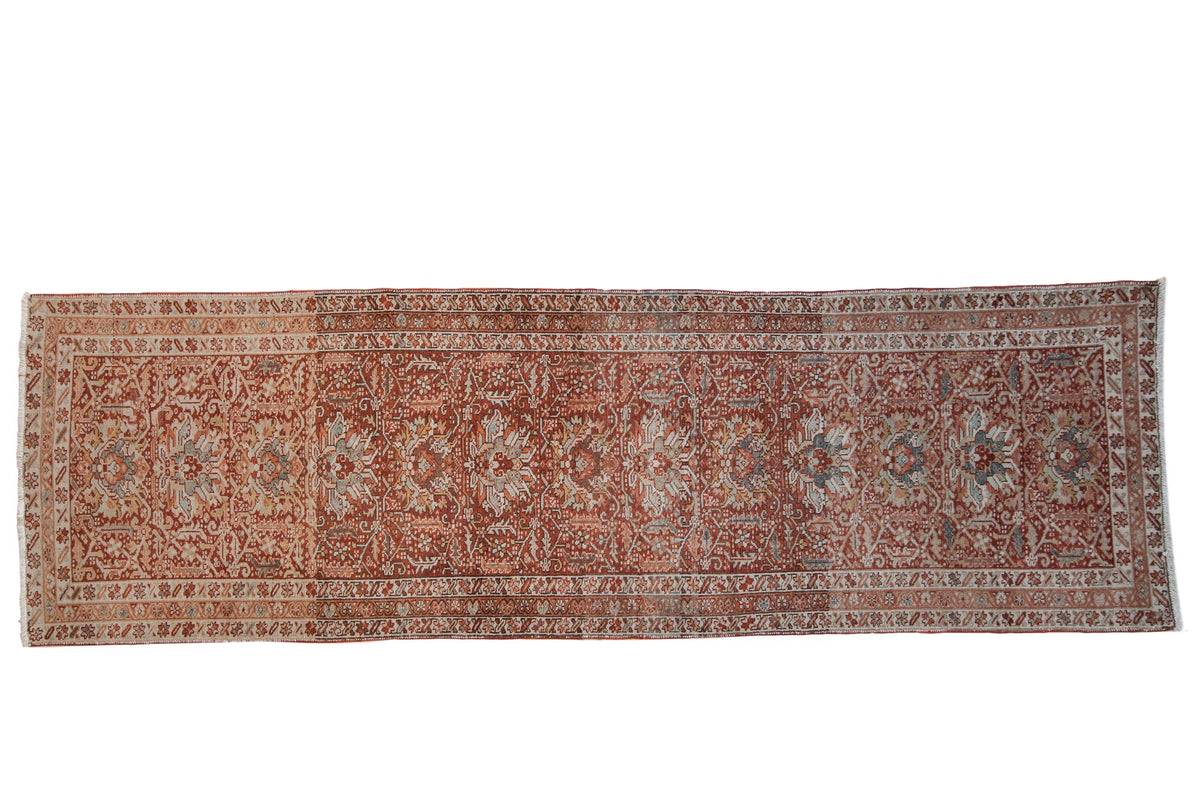 Vintage Karaja Persian runner with a distressed red field, allover palmettes, and interconnecting vinery.