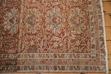Detailed floral border and evenly worn knot heads on a distressed Persian Karaja runner rug.