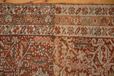 A close-up showing the even wear and low pile on a vintage Karaja rug's geometric border.