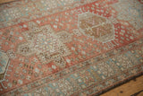 Even wear revealing faded blush and sand tones on Heriz runner's motifs.