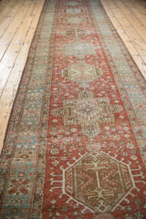 Vintage distressed Heriz rug runner medallion with geometric relief, blush, and ivory tones.