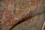 Distressed vintage Heriz rug runner geometric patterns in blush, pale brick red, and soft teal.