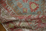 Supple drape of the distressed Heriz rug showing its hand-knotted texture and characterful wear.
