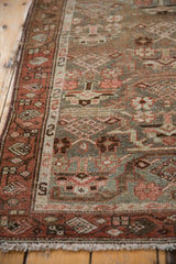 Distressed vintage Hamadan runner detail: worn pile, dusty blue, wine red geometric border.