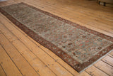 Distressed Hamadan runner detail: faded paneled lattice with vine border and intact side cord selvages.