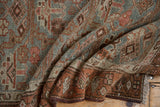 Folded Vintage Distressed Hamadan runner showcasing worn texture and geometric design in dusty blue and rust tones.