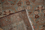 Distressed vintage Hamadan runner's worn pile, visible knot heads, and hand-knotted reverse.