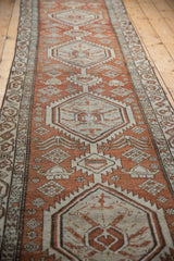 Distressed Northwest Persian runner with dusty brick red and ivory stylized pictorial motifs.