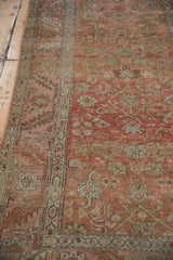 Antique distressed Bakshaish rug showing faded ruby red abrash and Herati motifs.