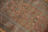 Textured view of the antique Bakshaish rug's faded Herati motifs and geometric border.