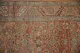 Distressed antique Bakshaish runner close-up, revealing Herati pattern, abrashes, and foundation showing.