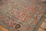 Distressed pile texture and soft abrashes on an antique Bakshaish Herati rug. Visible wear.