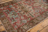 Distressed vintage Heriz runner showing wear to knot heads and secured side selvage.