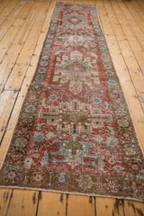 Heriz runner side detail with worn cherry red, powder blue patterns and intact selvage.