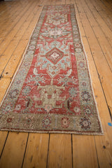 Close-up of distressed vintage Heriz runner, highlighting cherry red field, powder blue patterns, and aged pile texture.