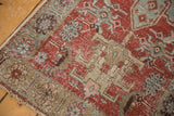 Side cord selvage and distressed cherry red field with geometric motifs.