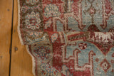 Distressed vintage Heriz runner corner, with visible even wear, cherry red, and powder blue patterns.