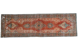 Distressed vintage Mahal runner with aged brick red and floral medallion design.