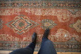 Distressed Mahal runner detail, showing worn pile texture, ornate brick red, beige, and dusty teal.