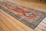 Distressed brick red Mahal runner with Rococo floral overlays and dusty teal accents.