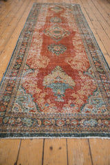 Distressed Persian Mahal runner end, rococo potted plant motif and textural brick red pile.