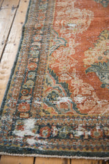 Distressed vintage Mahal rug with brick red, dusty teal, showing wear to knot heads and foundation.