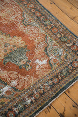 Distressed pile with Rococo stylized patterns in brick red, dusty teal, and beige tones.