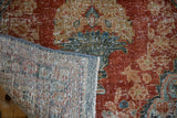 Distressed Mahal rug's brick red pile, wear to knot heads, and hand-knotted foundation.