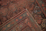 Vintage Kurdish rug with worn pile, madder red plant motif, and restored selvage.