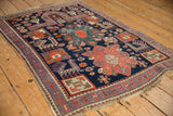 Squared medallion, pinwheel patterns, and purple border detail in navy, tangerine, and blush tones.