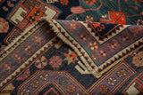 Vintage Caucasian rug corner, navy, purple, orange geometric patterns, short pile, fringe, selvage.