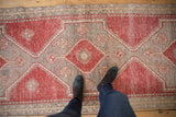 Distressed traditional geometric pile in pale cherry red and silver, featuring diamond motifs.