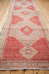 Distressed cherry red and silver geometric diamond motifs on a vintage Oushak runner.