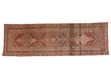 Decorative distressed Anatolian runner with madder red, pale raspberry medallions and arabesque border.