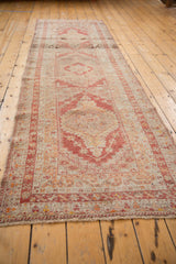 Distressed madder red arabesque border and short pile detail on vintage Anatolian runner.