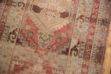 Distressed Anatolian rug runner close-up, showing madder red, silver, and brown geometric motifs.