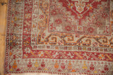 Distressed vintage Anatolian runner corner, madder red geometric borders and short pile.