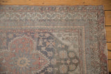 Corner detail of a vintage Anatolian runner showing compartmentalized borders in red, silver, and charcoal.