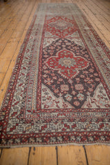 A long perspective view of a vintage Anatolian runner showing its series of medallions.