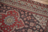 Cherry red medallion and charcoal field with intricate silver borders on a vintage Anatolian rug.