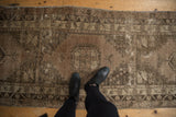 Vintage distressed Oushak runner in soft silver, beige, charcoal tones, worn texture.