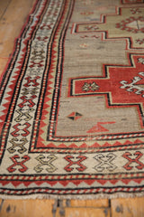 Low-pile texture and crab-style border detail on a vintage Caucasian rug with visible foundation.