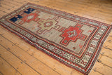 Vintage Caucasian runner with triple stepped medallions and a geometric crab-style border.